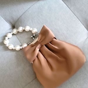 Small tan handbag with faux pearl handle